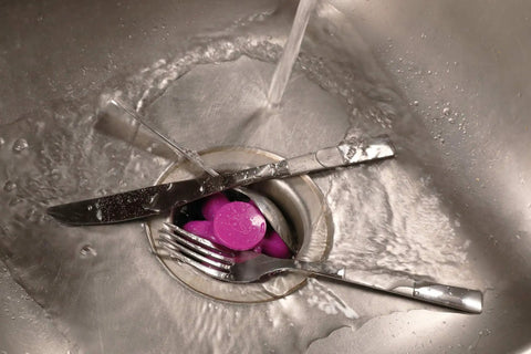 Disposal Genie II Garbage Disposal Strainer And Stopper in a sink, black finish, with utensils, keeps junk and silverware out of drain