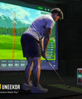 Golfer using Eye Mini Core Golf Launch Monitor And Simulator With Real Time Tracking and Near Zero Latency indoors.