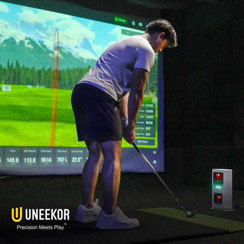 Golfer using Eye Mini Core Golf Launch Monitor And Simulator With Real Time Tracking and Near Zero Latency indoors.