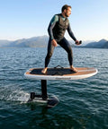 Man riding High Performance Carbon Fiber eFoil Jet Board For Water Sports With 8KW Motor Delivers Top Speeds Up To 60 Km H on a lake