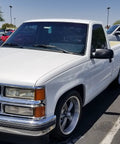 White Chevy Silverado 1500 1988-1998 showcasing lowering kit with 5 inch front drop spindles, coil springs, and 7 inch rear flip kit.