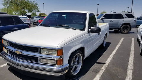 White Chevy Silverado 1500 1988-1998 showcasing lowering kit with 5 inch front drop spindles, coil springs, and 7 inch rear flip kit.