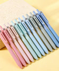 Gel Pens Set Of 12 Silent Click Retractable Pens With 0.5mm Fine Point Black Ink in pastel colors on a yellow background.