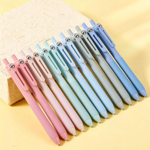 Gel Pens Set Of 12 Silent Click Retractable Pens With 0.5mm Fine Point Black Ink in pastel colors on a yellow background.