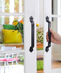 Person using Rustic Barn Door Handle 11 Inch Cast Iron Sliding Gate Pull Black Heavy Duty Fence Door Hardware, Vintage Long Gate Handle For Outdoor Garage Interior, 2 Pack on glass door.