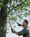 Man using Heavy Duty Bypass Loppers For Tree Trimming With German Stainless Steel Blades Rust Resistant And Beast Mode Sharp on tree