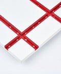 Close-up of Universal 48 Inch T Track with easy install predrilled mounting holes and wood screws, anodized red finish on white board.