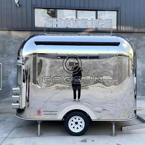 Built Different Stainless Steel Food Truck With Fully Loaded Commercial Kitchen Sleek Custom Mobile Concession Trailer from the side view.