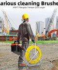 Worker holding Fiberglass Fish Tape 500Ft One Quarter Inch Duct Rodder Wire Puller with Steel Reel Stand at construction site.