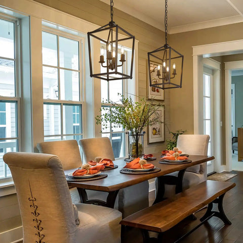 4 Light Black Farmhouse Chandelier With Open Iron Lantern Frame over dining table in bright room with large windows.