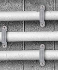 Killer One Inch Pvc Pipe Straps With Two Holes Rock Solid Conduit Clamps And Plastic Pipe Supports In Grey Color on pipes.