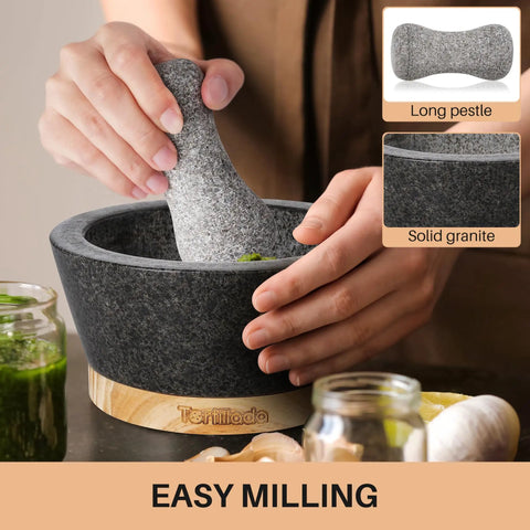 Person using 6 Inch Granite Mortar And Pestle Set With Anti Scratch Wood Base, Heavy Duty Grinder For Spices And Herbs