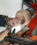 Heavy Duty Woodturning Hollowing Tool With Replaceable Carbide Tipped Round Blade And Solid Beech Handle in use shaping a wooden bowl on a lathe.