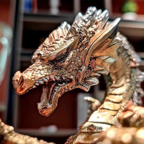 Close-up of a metallic steampunk dragon head on a wine bottle holder, part of a Steampunk Dragon Wine Bottle Holder With Two Glasses Metal Gothic Wine Rack For Home Bar Man Cave Decor Gift For Men 11 Point 6 Inch High Holds One Bottle And Two Glasses.