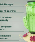 Green Cactus Top Fill Glass Hummingbird Feeder with metal hanger, 32 oz capacity, bee guards, and removable perches, partial side view