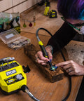 Person using Badass 18 Volt Cordless Mini Rotary Tool With 35 Premium Accessories for engraving on wood.