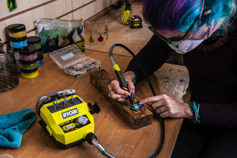 Person using Badass 18 Volt Cordless Mini Rotary Tool With 35 Premium Accessories for engraving on wood.