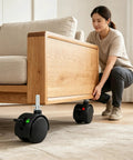 Smooth As Silk Heavy Duty 1.5 Inch Swivel Caster Wheels Set Of Four on a wooden sofa being adjusted by a person.
