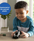 Child playing with Skid Steer Farm Toy Playset 1 To 32 Scale Die Cast Metal Construction With Realistic Bobcat Look Includes Farm Animals Fencing Hay Bales For Kids Ages 3 And Up on table.