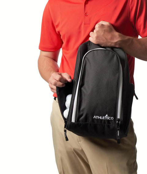 Man holding Golf Shoe Bag With Zippered Carrier And Ventilation External Pocket For Socks Tees And Accessories Easy Trunk Storage.