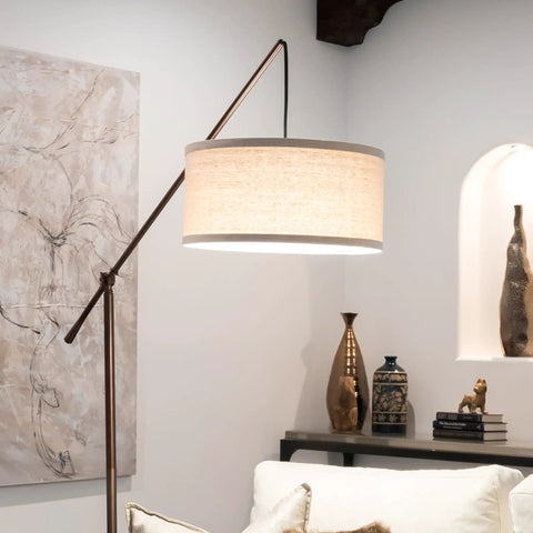 Tall Arc Floor Lamp With Sturdy Base In Rubbed Bronze LED Reading And Living Room Light Adjustable Arm For Dope Mid Century Modern Vibe Bedroom And Office Decor beside a sofa in a chic living room.