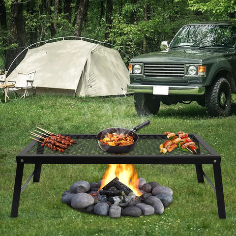 Foldable Portable Campfire Grill with Legs Made from Heavy Duty 304 Stainless Steel in outdoor campsite setting