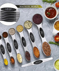 16 Piece Measuring Cups And Magnetic Spoons Set In Stainless Steel With 8 Nesting Cups And 7 Double Sided Magnetic Measuring Spoons Plus A Leveler For Dry And Liquid Ingredients A Handy Kitchen Must Have shown in a flat lay.