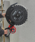 Job Site Ready 16 Inch Wet Dry Electric Concrete Cutting Saw With Integrated Water Pump And Extended Hose For Crisp Dust Free Grooving On Granite Tile Stone Wood And Brick Works Heavy Duty 4000 Watt Power Rig cutting through concrete with a diamond blade.