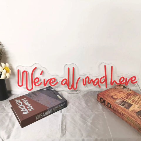 25 Inch Were All Mad Here Neon Sign LED Red Light For Wall Decor on shelf with books, handmade design