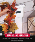 Front view: black adhesive Velcro strip on white door trim being applied to hang autumn wreath.
