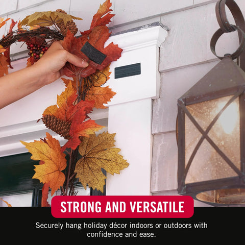 Front view: black adhesive Velcro strip on white door trim being applied to hang autumn wreath.