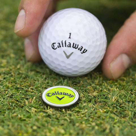 Golfer placing ball next to lime magnetic marker from Super Handy Four In One Golf Divot Repair Tool Built With Tough Zinc Alloy.
