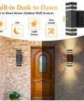 Dusk To Dawn Porch Light With Outlet And Up Down Exterior Wall Fixture illuminating brick wall by door.