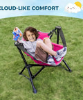 Child sitting in Kids Hammock Chair For Camping And Travel, Adjustable Folding Chair With Stand, on a grassy lawn.