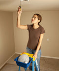 Person using ladder with AC52-UB Ladder Accessory Kit With Liquid Holder Swiveling Carry Handle and Tool Towel Dock