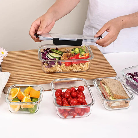 Person using 8 Pack Glass Food Storage Containers With Airtight Locking Lids For Meal Prep And Leftovers Leak Proof Design Microwave Oven Freezer And Dishwasher Safe BPA Free Variety Size Set For Portion Control And On The Go Lunches filled with fresh food.