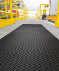 Commercial Grade Vinyl Diamond Plate Floor Mat Knockout Traction Tough As Nails Oil And Chemical Resistant Protection For Heavy Traffic Garages Professional Workshops Black Yellow Border on a metallic platform.