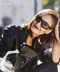 Badass Z87 Rated Photochromic Motorcycle Safety Glasses With Shatterproof Lens And Matte Black Shell on a woman in a black leather jacket.