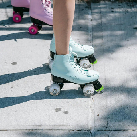 Roller skate brake stoppers toe plugs with screws, green, on blue quad skates on concrete