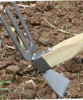 All Purpose Garden Hoe And 2-In-1 Digging Fork with carbon steel 3-prong tine and blade in use on garden soil, wooden handle visible