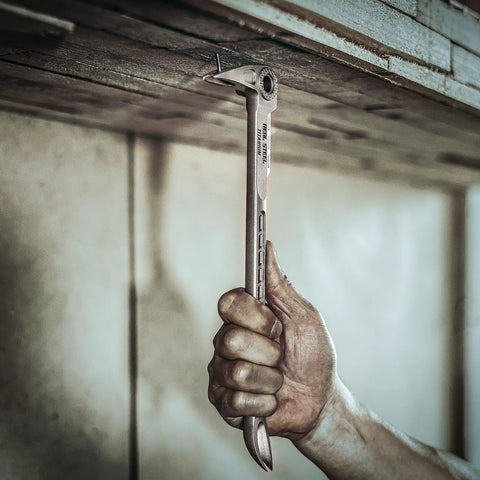 Hand using 12 Inch Titanium Nail Puller Dual Ended Cats Paw Pry Bar Crowbar For Construction Heavy Duty One Piece Forged Titanium on wood