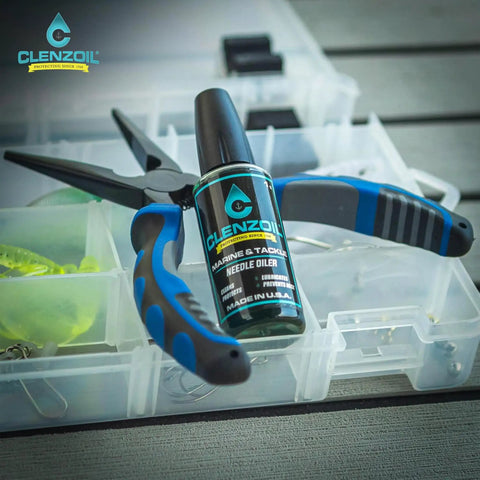Marine And Tackle Gear Oil Lubricant For Fishing Reels, Boat Motors, Downriggers And More With Precision Needle Oiler 1 Oz bottle with pliers on tackle box