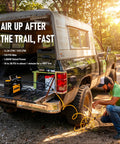 Heavy Duty 12V Air Compressor For 4X4 Trucks Portable Dual Cylinder Tire Inflator With 150 Psi Output and LCD Panel in use at sunset