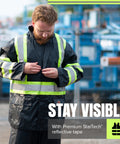 High Visibility Lightweight Waterproof Safety Rain Suit Featuring Reflective Work Jacket, male adjusting zipper in outdoor setting.