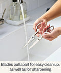 Heavy Duty Kitchen Shears 8 Inch German Stainless Steel Poultry Scissors, blades apart being rinsed at kitchen sink