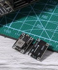Two Six Pack 5V Buck Converter Modules Set 5V 30V To 5V DC DC Regulator Board MP1584EN on a green cutting mat