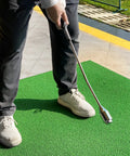 Golfer using Dope Golf Swing Trainer Aid for right handed players with non slip rubber handle and adjustable head for smoother swing.