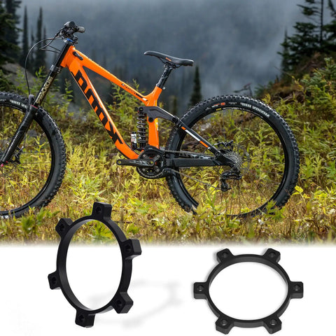 Boost Hub Conversion Adapter For Front And Rear Wheels, Converts 100mm By 15mm To 110mm By 15mm Or 142mm By 15mm To 148mm, Aluminum Alloy, 6 Hole, Spacers And Screws Included with mountain bike background.