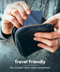 Front view of hands pulling a navy blue Care Touch microfiber cleaning cloth from a small zippered pouch.