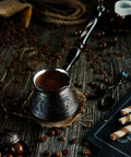 Thick Copper Turkish Coffee Pot Cezve Ibrik Briki With Wooden Handle And Hand Engraving Antique Copper Finish on rustic table